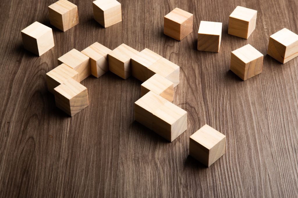 Forming bigger question mark. question mark on wooden table background